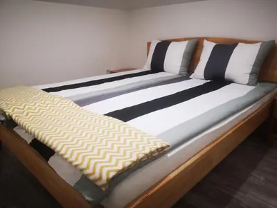 a bed with black and white pillows on it at Edo in Visoko
