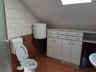 a bathroom with a toilet and a sink at Apartman Kupres Centar in Kupres