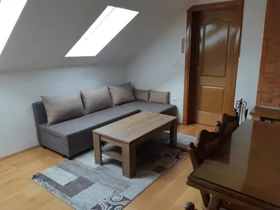 a living room with a couch and a table at Apartman Kupres Centar in Kupres