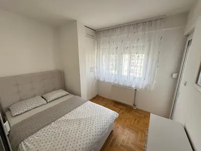 a small bedroom with a bed and a window at Apartment 4th. Floor in Banja Luka