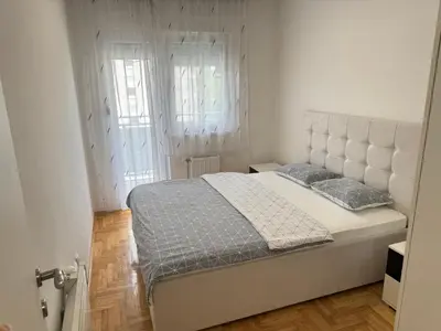 a bedroom with a large white bed with two pillows at Apartment 4th. Floor in Banja Luka