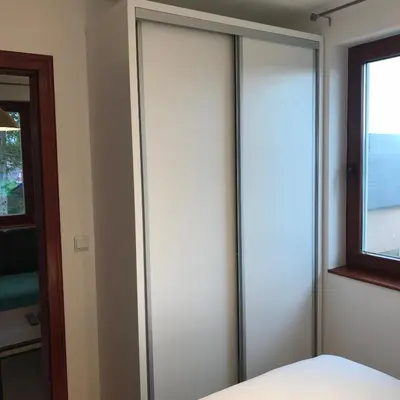 a bedroom with sliding glass doors and a bed at 4 Seasons Vlašić Lux Apartments in Vlasic