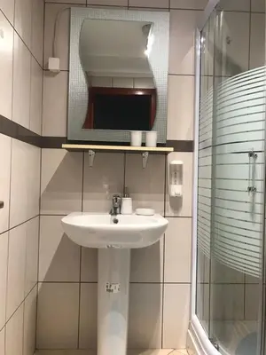 a bathroom with a sink and a mirror at 4 Seasons Vlašić Lux Apartments in Vlasic