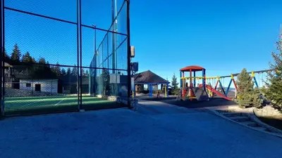 a playground with a slide and a play structure at 4 Seasons Vlašić Lux Apartments in Vlasic