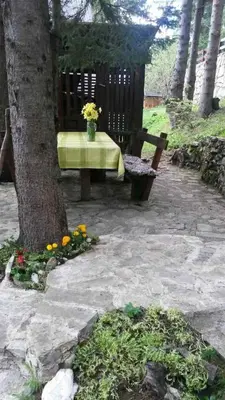 a picnic table and a bench next to a tree at Ismar&Hanna in Vlasic