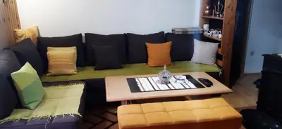 a living room with a couch with pillows and a table at Ismar&Hanna in Vlasic