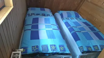 two beds in a room with blue sheets at Ismar&Hanna in Vlasic