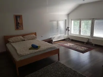 a bedroom with a bed with a blue hat on it at Vinac guest house in Jajce