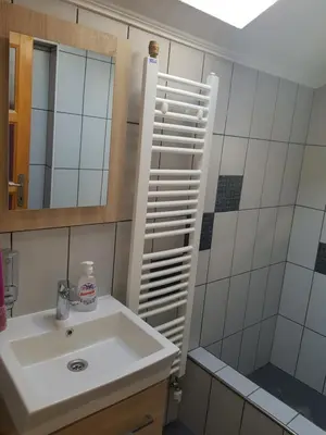 a bathroom with a sink and a shower and a mirror at Vinac guest house in Jajce