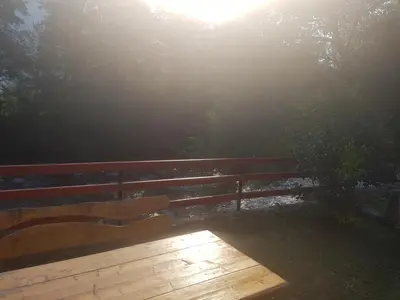 a wooden bench in front of a fence at Vinac guest house in Jajce
