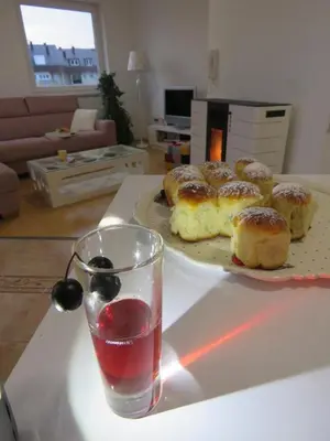 a table with a plate of donuts and a glass of water at Winter Iris in Kupres