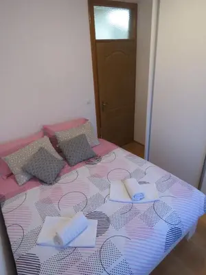 a pink and purple bed with pillows on it at Winter Iris in Kupres