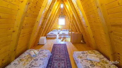 a room with four beds in a bamboo house at Pyramid Energy House in Visoko