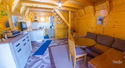 a dining room and kitchen in a log cabin at Pyramid Energy House in Visoko