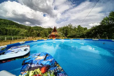a large swimming pool with a roller coaster in the background at Pyramid Energy House in Visoko