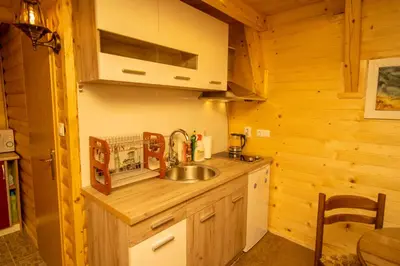 a kitchen with a sink in a wooden cabin at Pyramid Energy House in Visoko