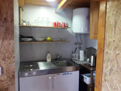 a small kitchen with a sink and a stove at Obiteljski Apartman Borovi in Visoko