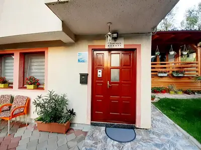 a red door on the side of a house at Obiteljski Apartman Borovi in Visoko