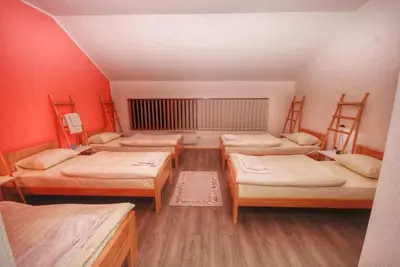 a room with four beds in a room at Apartmani 077 in Drvar