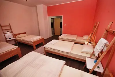 a room with four bunk beds and a mirror at Apartmani 077 in Drvar