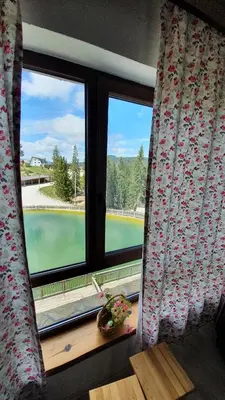 a window with a view of a tennis court at Eko-FIS Vlašić in Vlasic