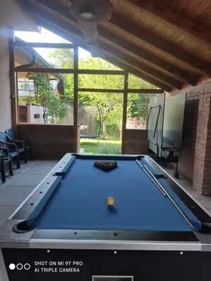 a pool table in the middle of a patio at Villa Katarina with pool in Banja Luka