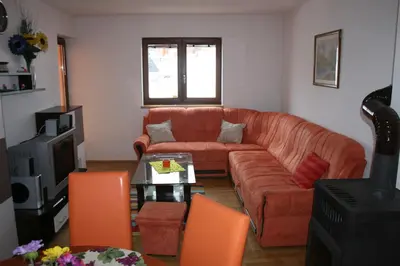 a living room with a couch and a table at Apartman Kupres Holiday in Kupres
