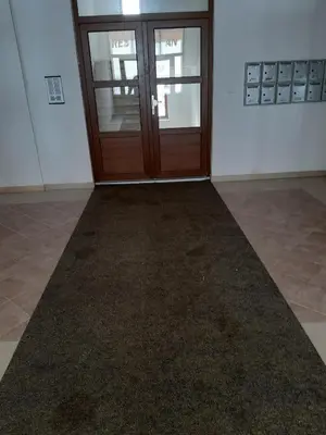 an empty room with a door and a carpet at Apartman Kupres Holiday in Kupres