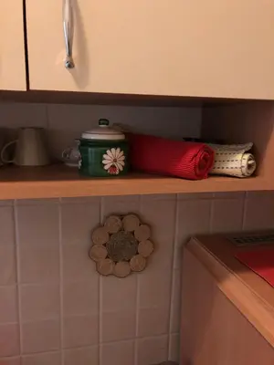 a shelf in a kitchen with various items on it at Fortuna in Banja Luka