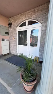 a plant in a pot in front of a door at Fortuna in Banja Luka