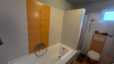 a bathroom with a tub and a toilet at Fortuna in Banja Luka
