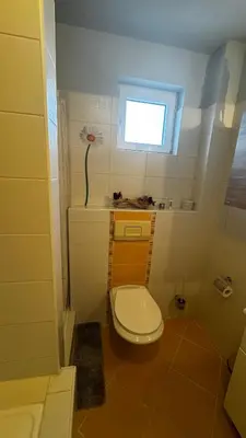 a small bathroom with a toilet and a window at Fortuna in Banja Luka