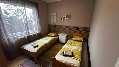 two beds in a small room with a window at Fortuna in Banja Luka