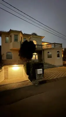 a house with a light on the front of it at Fortuna in Banja Luka