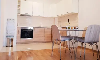 a kitchen with a table and two chairs in it at Apartman Lukana in Banja Luka