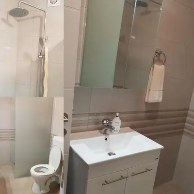 a bathroom with a sink and a toilet and a mirror at Apartman Lukana in Banja Luka