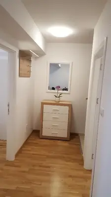 an empty room with a dresser and a window at Apartman Lukana in Banja Luka