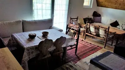 a living room with a table and a couch at Vikendica Armin in Vlasic