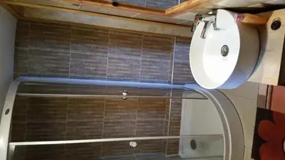 a shower with a glass door in a bathroom at Vikendica Armin in Vlasic