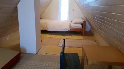 a small room with a bed in a attic at Vikendica Armin in Vlasic