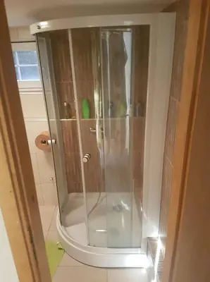 a shower with a glass door in a bathroom at Vikendica Armin in Vlasic