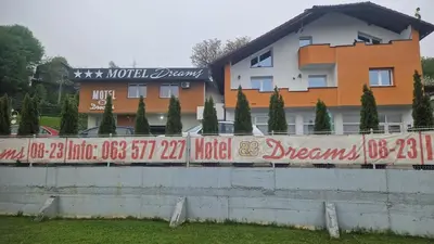 a wall with writing on it in front of a building at Motel Dreams in Novi Travnik