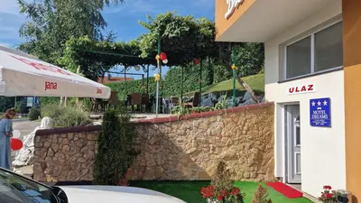a stone wall in front of a building at Motel Dreams in Novi Travnik