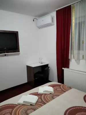 a hotel room with a bed with two towels on it at Motel Dreams in Novi Travnik