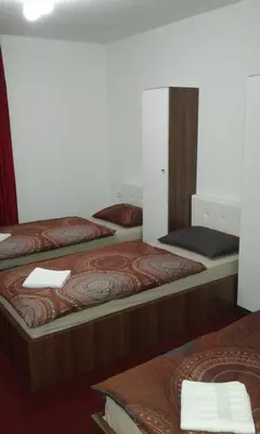 a room with three beds in a room at Motel Dreams in Novi Travnik