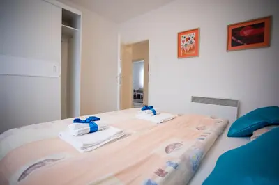 a bedroom with a bed with towels on it at Guest house PiN in Laktaši