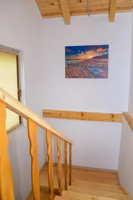 a staircase in a house with a picture on the wall at Forest Dream Lake House in Jajce