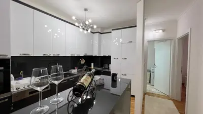 a kitchen with two wine glasses on a counter at apartman nejra in Tuzla