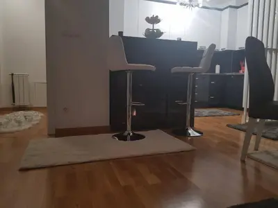 a living room with two chairs and a table at apartman nejra in Tuzla
