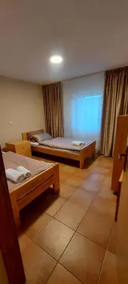 a hotel room with two beds and a window at Green House Izvor Vrilo in Tomislavgrad